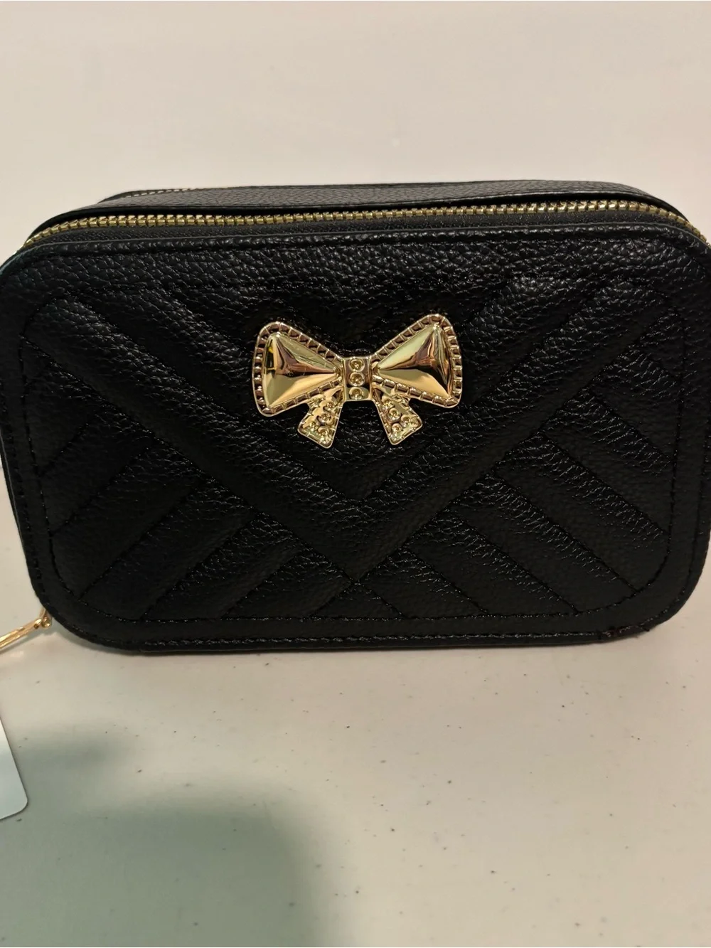 Black Quilted Bow Crossbody Bag with Gold Accent now. New